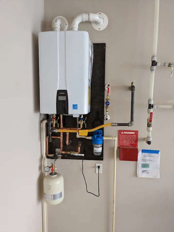 Professional plumber installing copper piping in a Plattekill home